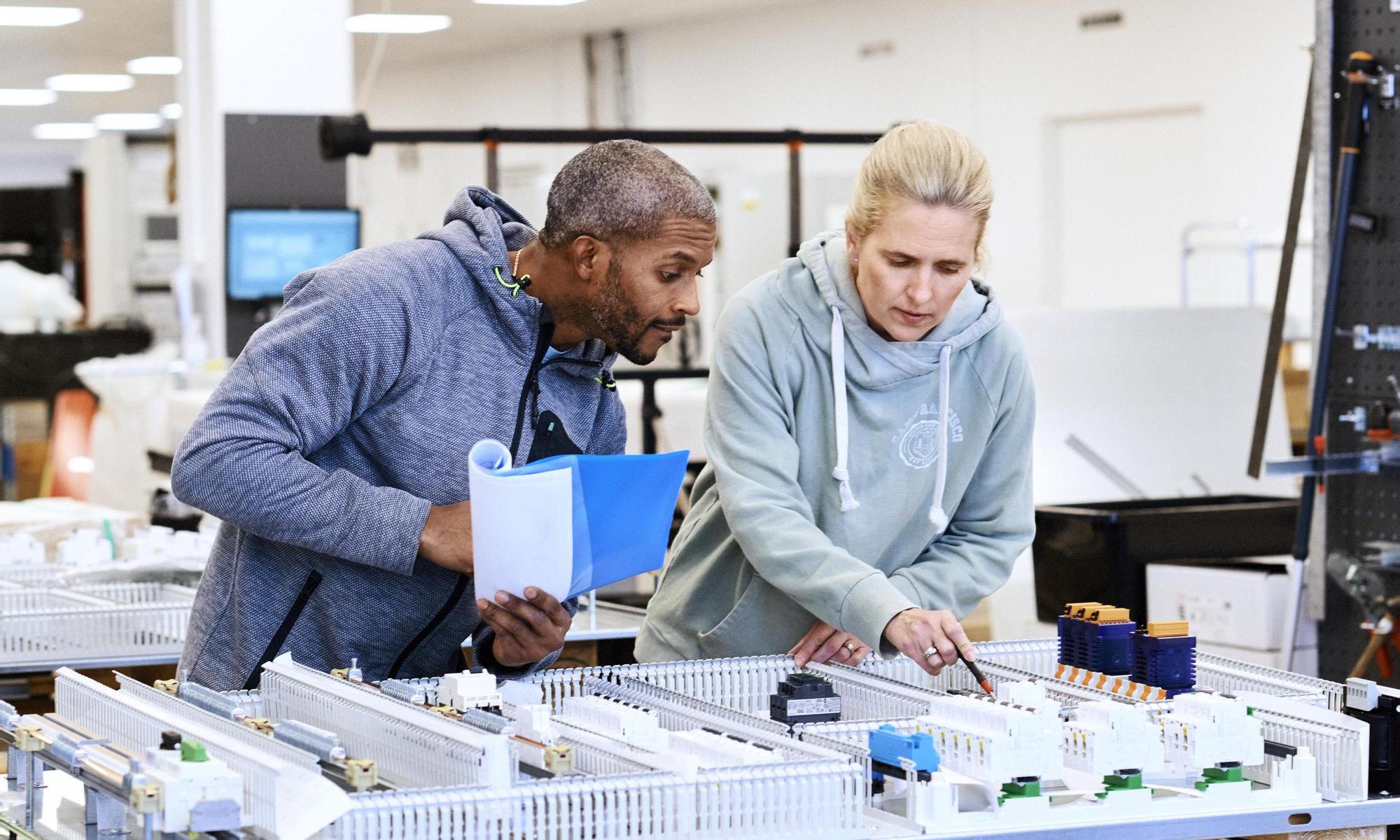 Man and woman focusing on detailed work