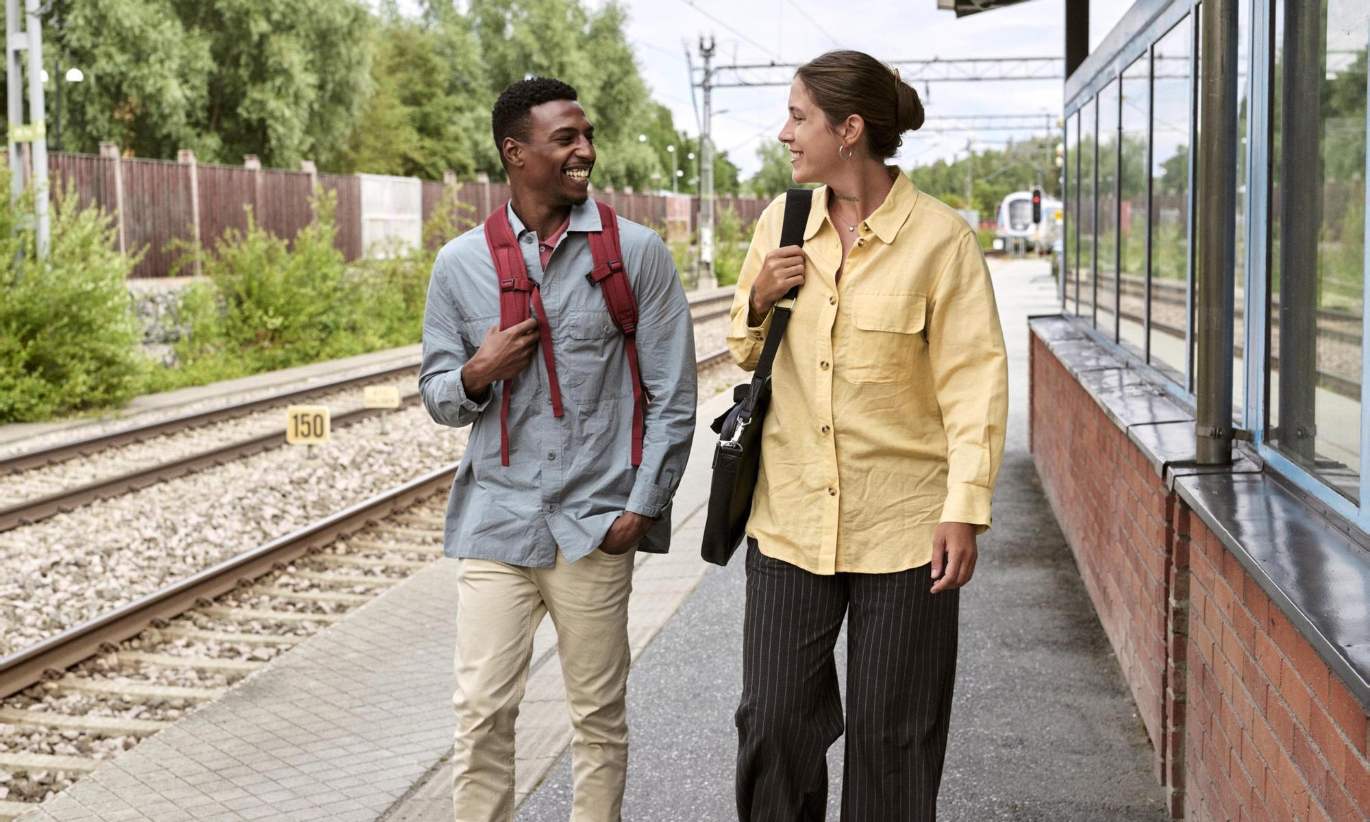 Man and woman on their way on a train station