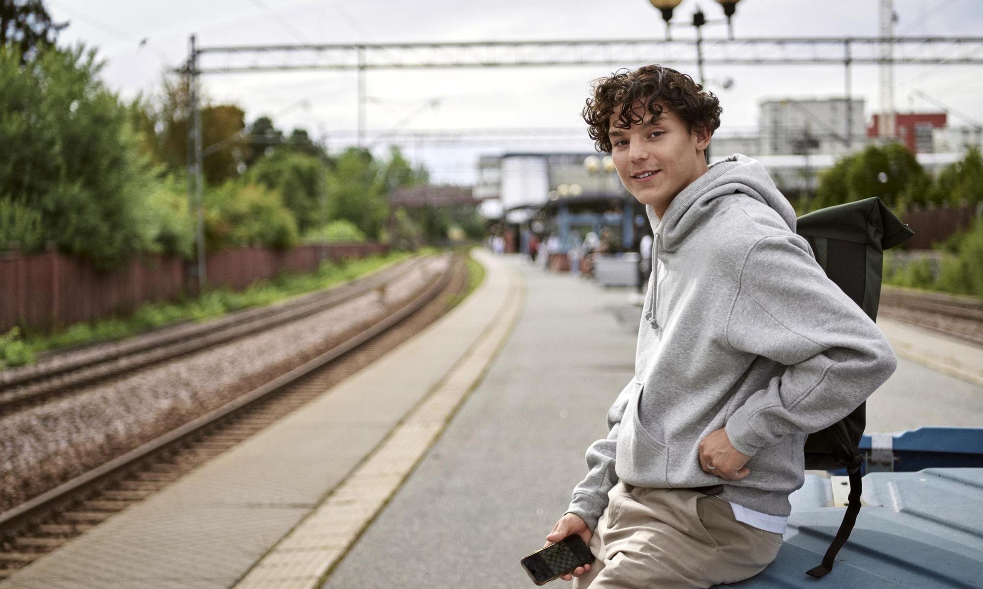 Young adult waiting at the train station