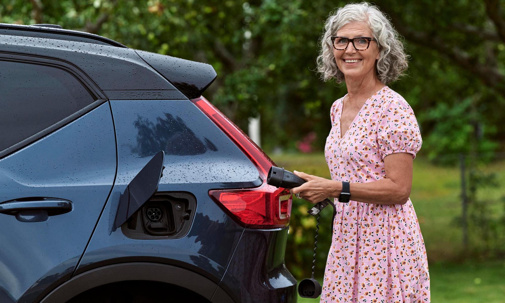 Woman charging electric car