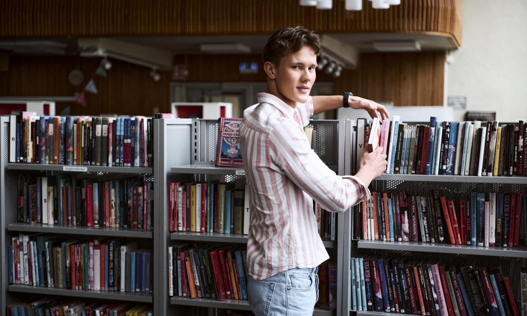 Student searching for books in the library