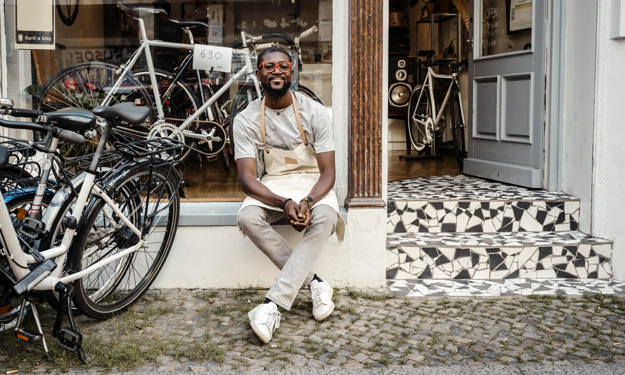 Business owner outside his bike shop