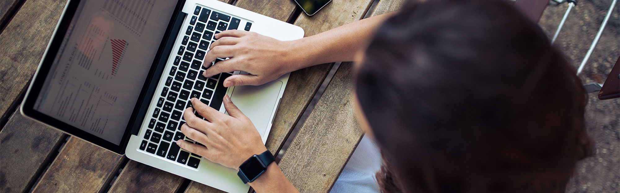 Woman using her laptop at a coffee shop.