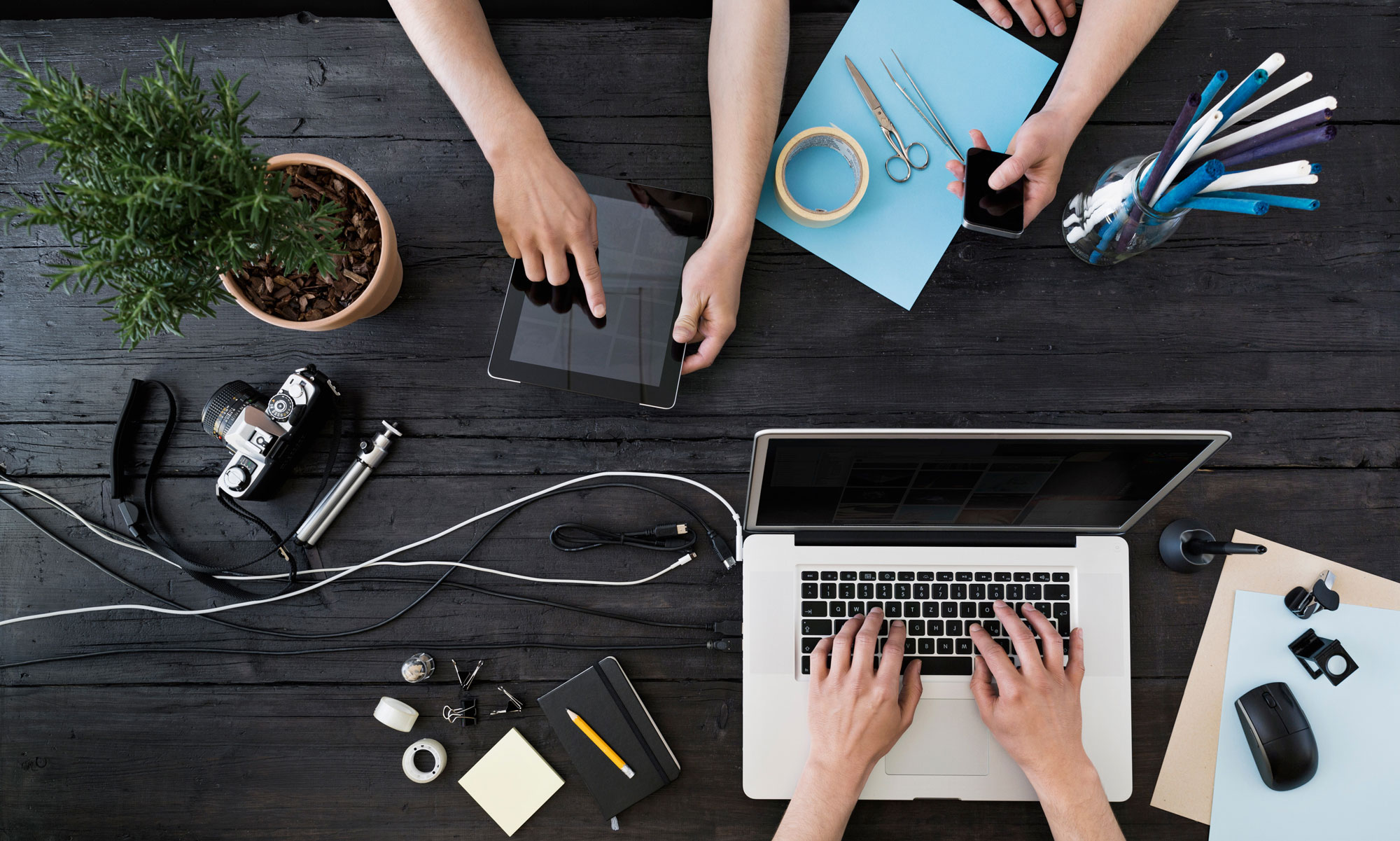 Digital devices with hands, tablet, laptop, smartphone